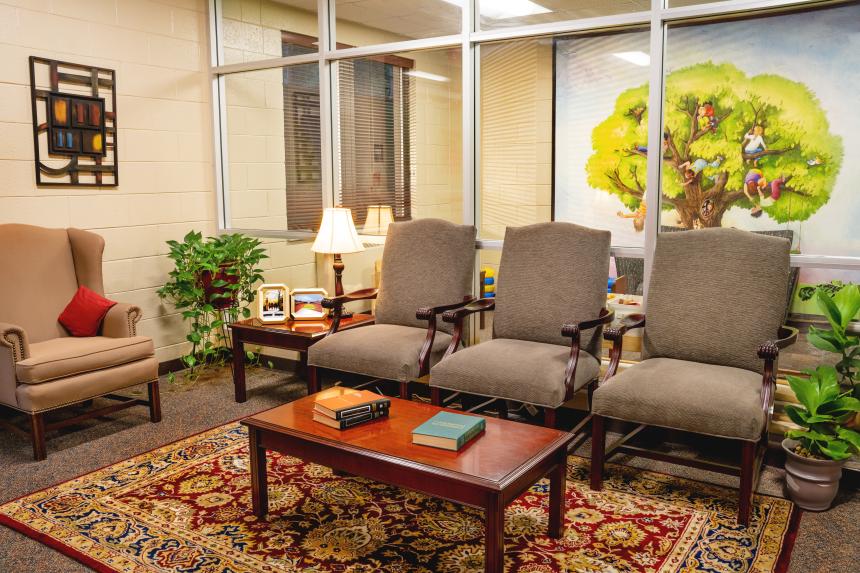 armchairs surrounding a coffee table in the clinic waiting room